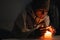 Young man without electricity at home with candle. Shutdown of heating and electricity, power outage, blackout, load