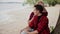 Young man embracing smiling girlfriend at beach