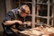 A young man is engaged in the family craft of making leather shoes in a workshop.