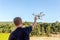 Young man, an engineer pilot, a drone, prepares quadrocopter for take-off, for testing and filming a vileo and