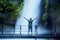 Young man enjoying Situ Gunung waterfall view