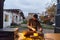 A young man is entertaining a group of friends in the backyard of his house, becoming their DJ and playing music in a