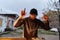 A young man is entertaining a group of friends in the backyard of his house, becoming their DJ and playing music in a