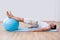 Young Man Exercising On A Pilates Ball