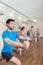 Young man exercising with the resistance bands of an anchor gym system