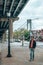 Young man exploring Brooklyn in New York under Verrazzano-Narrows bridge