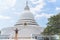 Young man exploring the Japanese Peace Pagoda in Sri Lanka