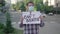 Young man in face mask standing with I can`t breathe placard on urban city street. Portrait of male Caucasian