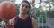 Young man, face and spinning basketball on court for sport, fitness wellness and team training in outdoor. Mexican