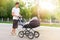 Young man, father, walking with a stroller on the street, the concept of fatherhood, child care
