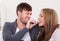 Young man feeding chocolate bar to his girlfriend