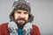 Young man feeling cold trying to keep warm, shaking and shivering, wearing gloves and knitted scarf