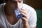 Young man feeling thirsty dehydrated holding glass drinking wate