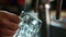 Young man is filling glass with beer in grill bar.