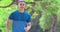 Young man in fitness wear and running in the park at morning