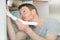 Young man fitting sink pipe