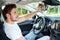 Young man fixing mirror in car