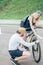 Young man fixing a wheel of bicycle