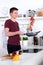 Young man flipping chopped vegetables in the pan