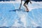 Young man flowriding and flowboarding on artificial sheet waves