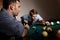 Young man focusing on playing snooker