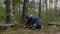 A young man found two large white mushrooms in the forest.