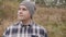 Young Man In Freak Hat Inspects The Surroundings Outdoors