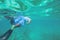 Young man free diving and snorkelling on a reef near Punta Cana