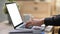 Young man freelancer hands typing on keyboard of laptop computer.