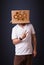 Young man gesturing with a cardboard box on his head with spur w