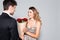 Young man gifting bouquet to woman