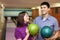 Young man and girl hold balls and laugh