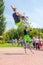 A young man and a girl jump on jumpers on the Volga embankment on a summer sunny day