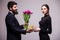 Young man give a gift for his girlfriend and tulips bucket