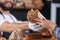 Young man giving fresh bread to woman in bakery