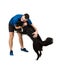 Young man giving a hug to his obedient lovely border collie dog isolated over white background. Human and pet friendship. Master