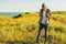 Young man, in glasses and in a cap with a backpack, hiking and enjoying the mountain landscape, adventure man hiking in the desert