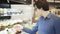 Young man in glasses picking a fresh salad in a shop