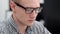 Young man in glasses working in the office