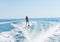 Young man glides on water skiing on the waves on the sea, ocean. Healthy lifestyle. Positive human emotions, feelings,