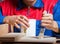 Young man gluing wood pieces together in DIY concept