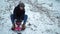 Young man goes sledding in winter. Steamy descent from a snow-covered mountain.