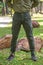 Young man in green pant standing  in the park