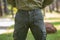 Young man in green pant standing  in the park