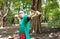 A young man in a green T-shirtshoots from a large slingshot.