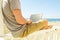 Young man in grey shirt sitting at the beach, working on laptop. Blogger, writer, coder, remote worker surfing browsing researchin