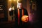 Young man in Halloween priest costume holding carved pumpkin in front of camera