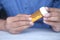 young man hand holding medicine pill container white sited