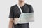 Young man with hand injured wearing splint, broken arm,  on white background