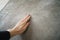 Young man hand touching concrete wall